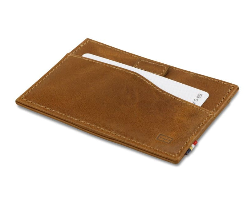 Front view of Leggera Card Holder Brushed in Brushed Cognac with a pull tab with a card.