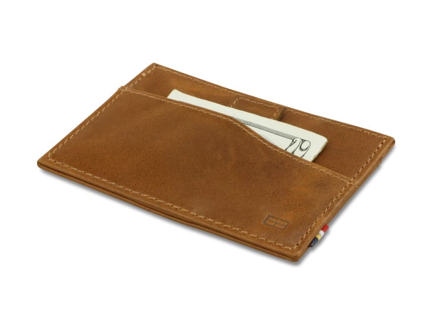 Front view of Leggera Card Holder Brushed in Brushed Cognac with a pull tab with money.