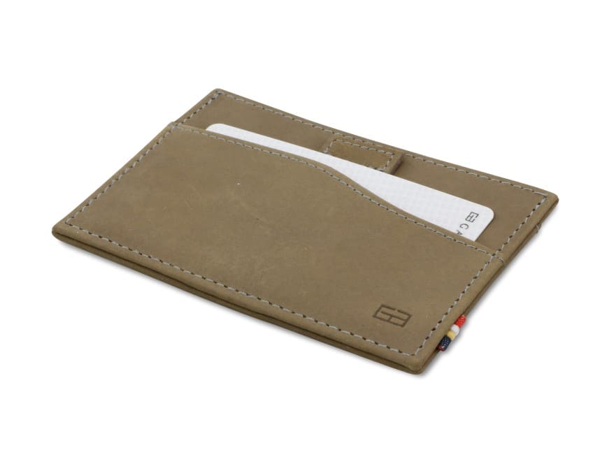 Front view of Leggera Card Holder Vintage in Metal Grey with a pull tab with a card.