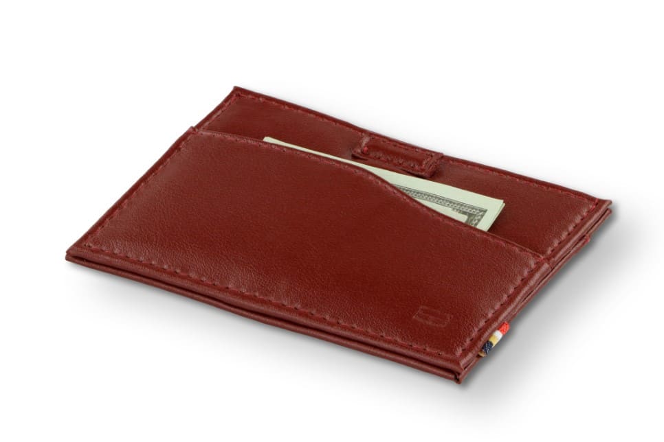 Front view of Leggera Card Holder Vegan in Cactus Burgundy with a pull tab with money.