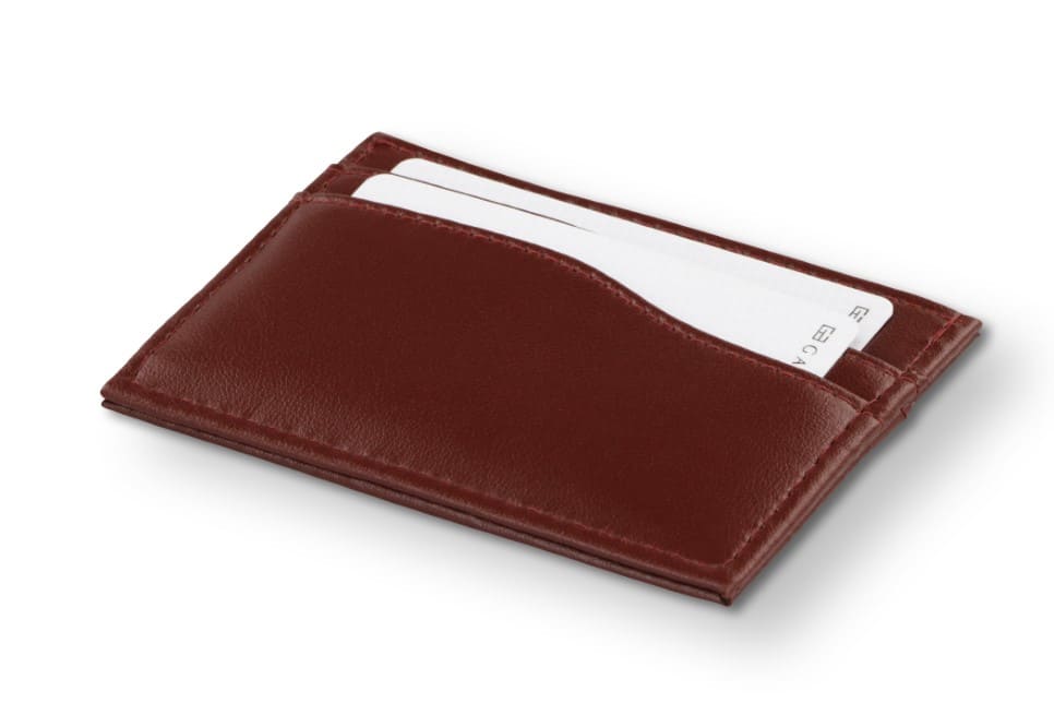 Front view of Leggera Card Holder Vegan in Cactus Burgundy with a pull tab with a card.