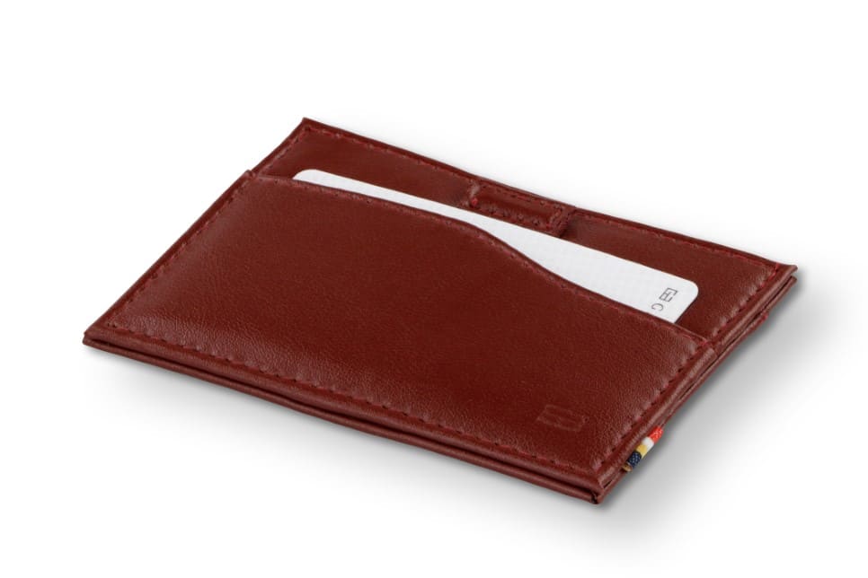 Front view of Leggera Card Holder ID Window Vegan in Cactus Burgundy with a pull tab with a card.