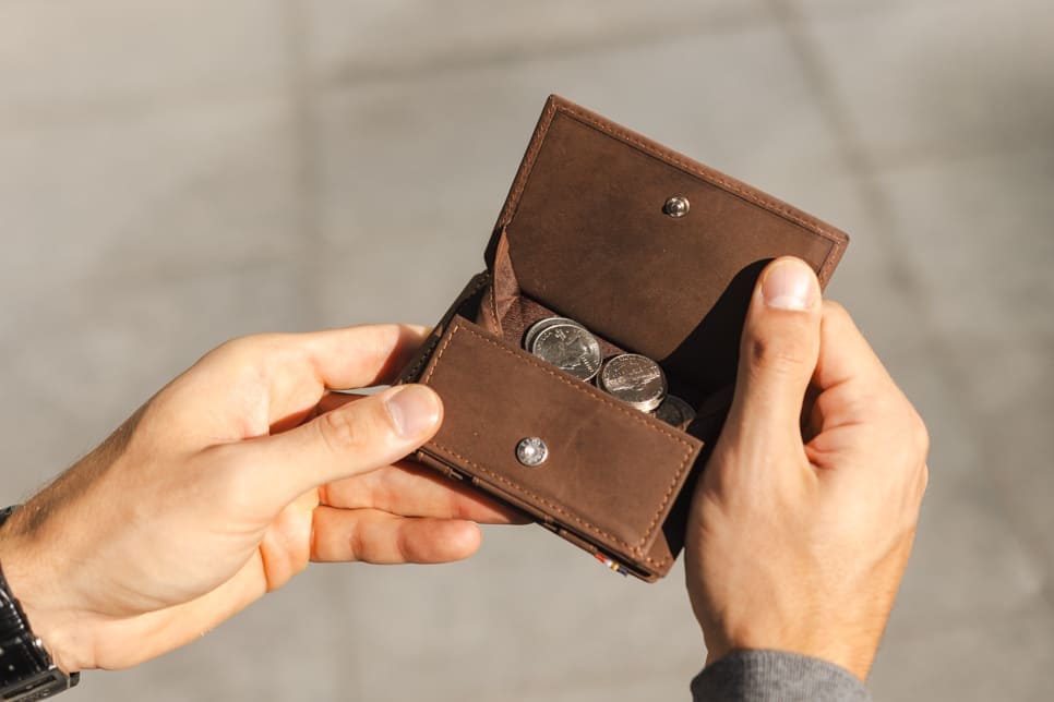 hand holding the coin pocket of the Cavare Magic Coin Wallet 