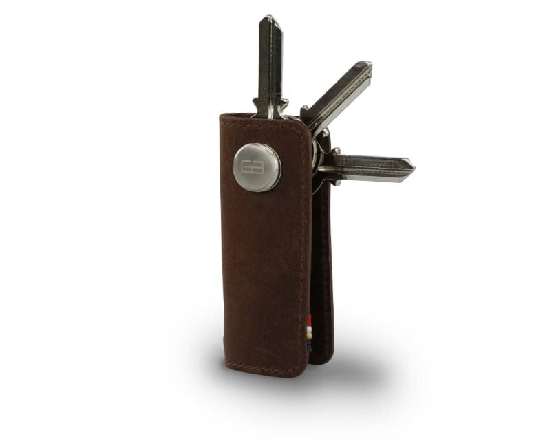 Side view of Lusso Vintage Key Holder in Brushed Brown with with a key holder ring and 3 keys. 