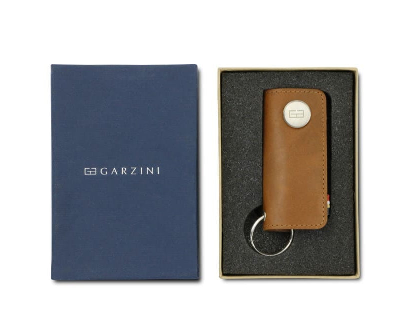 Front view of the Lusso Vintage Key Holder in Brushed Cognac in the box with the brand name Garzini. 