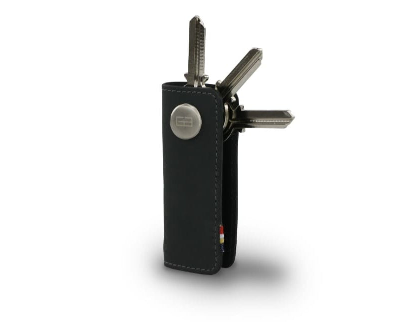 Side view of Lusso Key Holder in Carbon Black with with a key holder ring and 3 keys. 