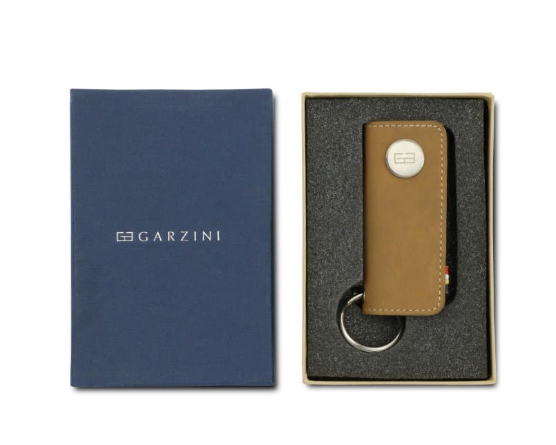 Front view of the Lusso Key Holder in Camel Brown in the box with the brand name Garzini. 