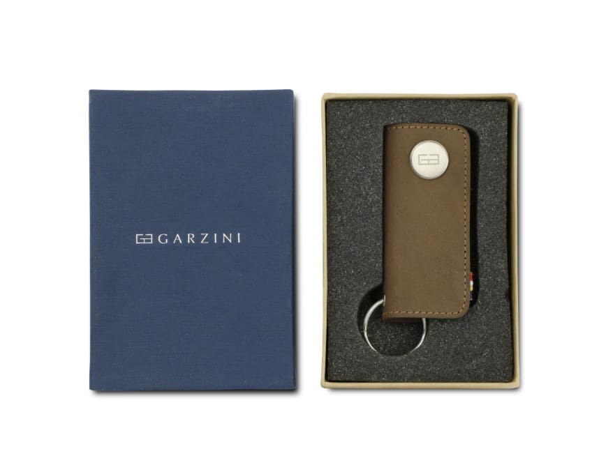 Front view of the Lusso Key Holder in Java Brown in the box with the brand name Garzini. 