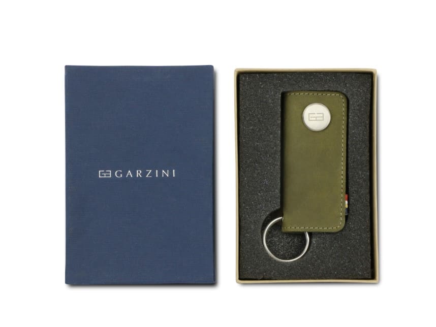 Front view of the Lusso Key Holder in Olive Green in the box with the brand name Garzini. 