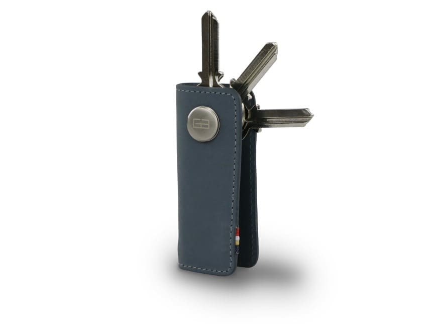 Side view of Lusso Key Holder in Sapphire Blue with with a key holder ring and 3 keys. 