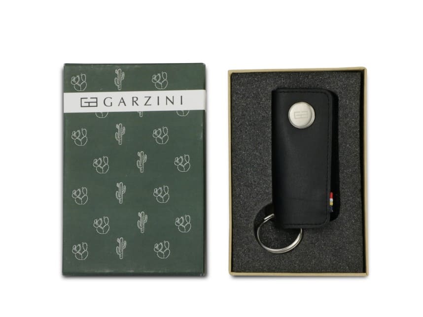 Open green box with the brand name and little cactus icons and front view of the Lusso Key Holder Vegan in Cactus Black in the box