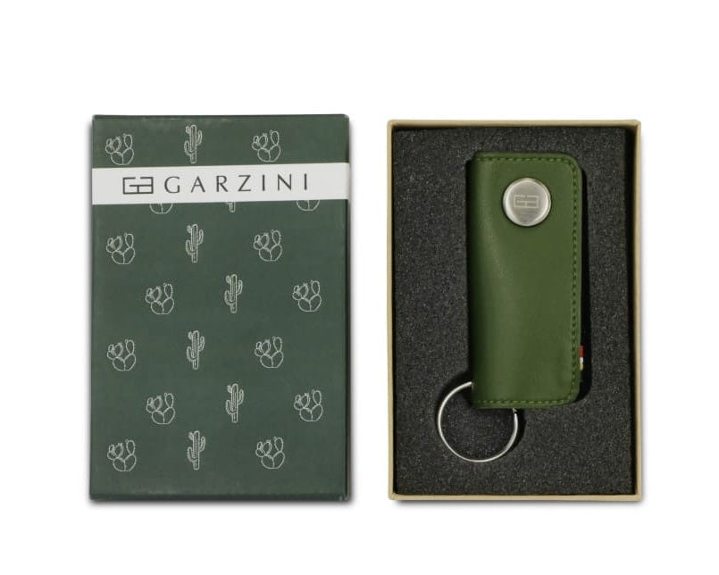 Open green box with the brand name and little cactus icons and front view of the Lusso Key Holder Vegan in Cactus Green in the box