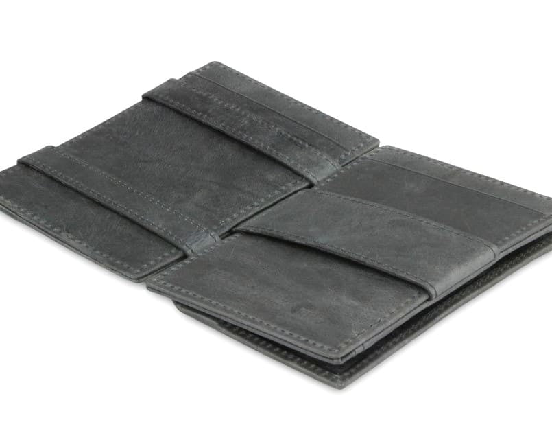 Open view of the  Essenziale Magic Coin Wallet Brushed in Brushed Black with the money strap to secure money.
