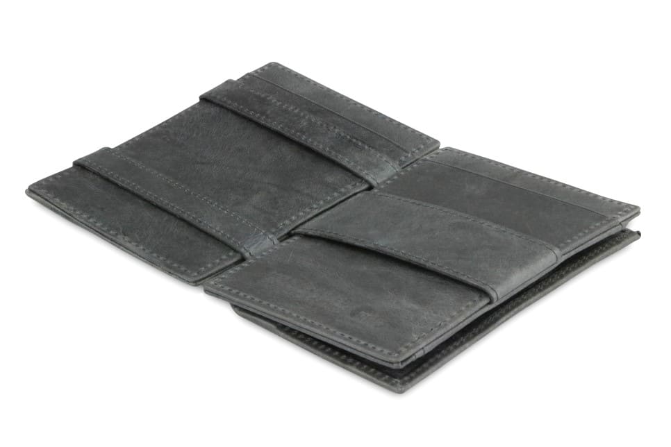 Open view of the  Essenziale Magic Coin Wallet Brushed in Brushed Black with the money strap to secure money.