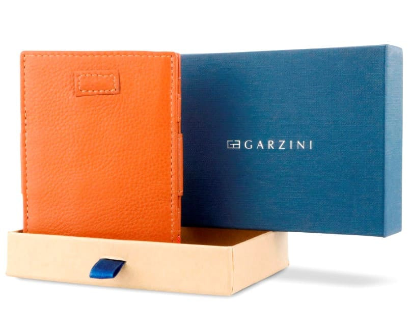 Half-open blue box with Garzini brand name Inside the box, the Cognac Brown wallet is wrapped in tissue paper, placed in a light cardboard box with a blue strap.