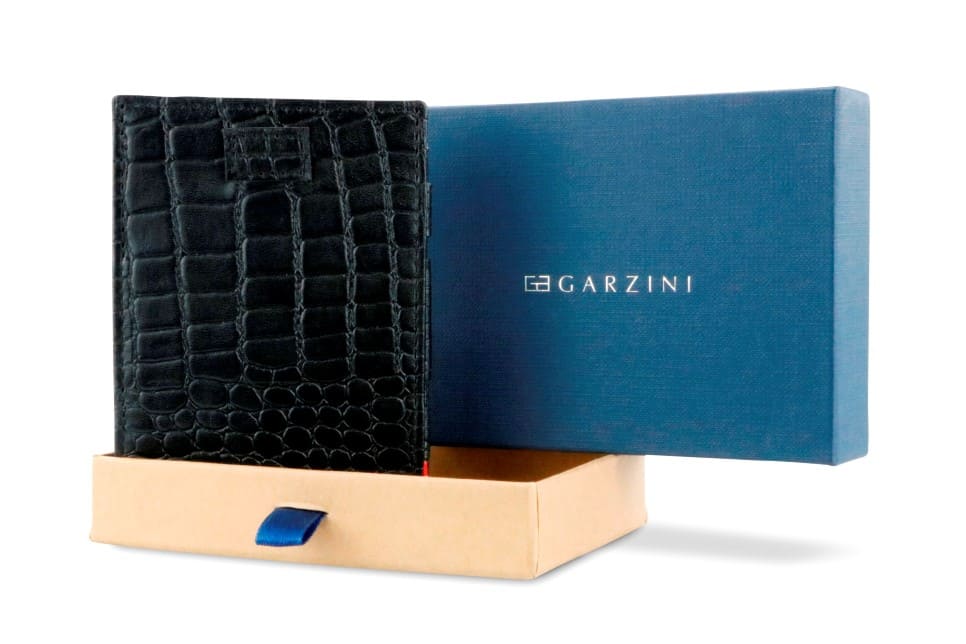 Half-open blue box with Garzini brand name Inside the box, the Black wallet is wrapped in tissue paper, placed in a light cardboard box with a blue strap.