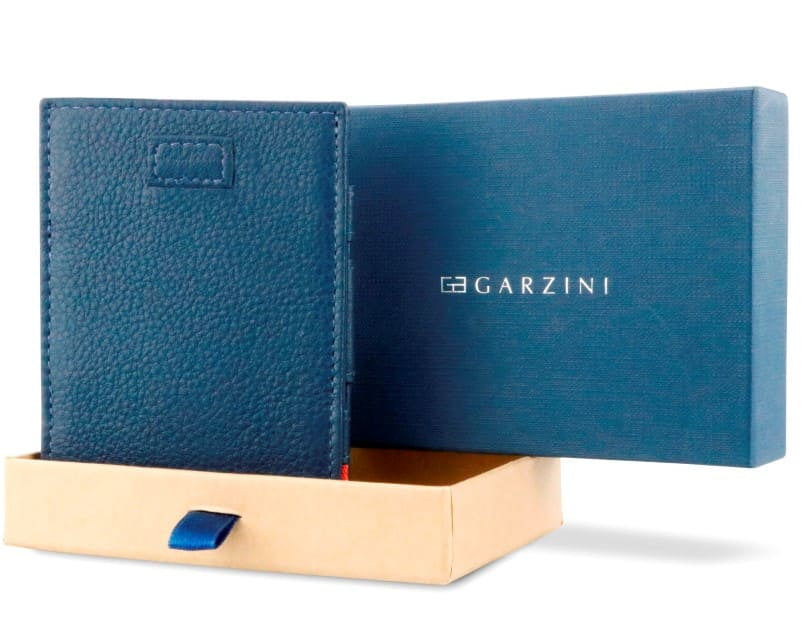 Half-open blue box with Garzini brand name Inside the box, the Navy Blue wallet is wrapped in tissue paper, placed in a light cardboard box with a blue strap.