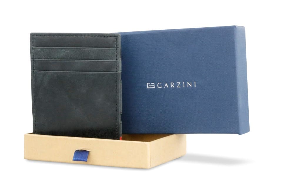 Half-open blue box with Garzini brand name. Inside the box, the Black wallet is wrapped in tissue paper, placed in a light cardboard box with a blue strap