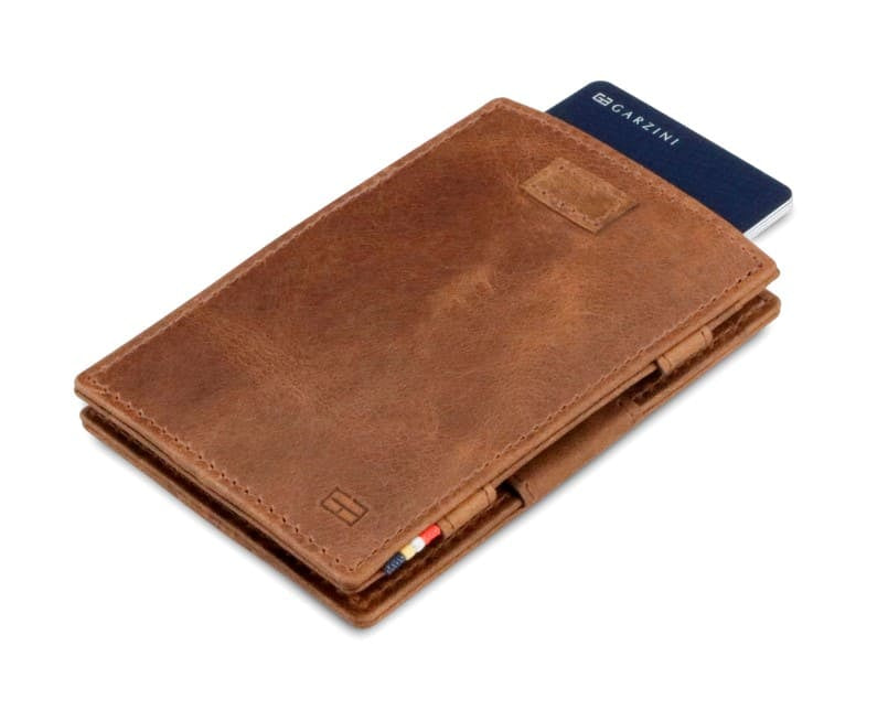 Front view of Cavare Magic Wallet Brushed in Brushed Brown with pull tab and card pulling out.