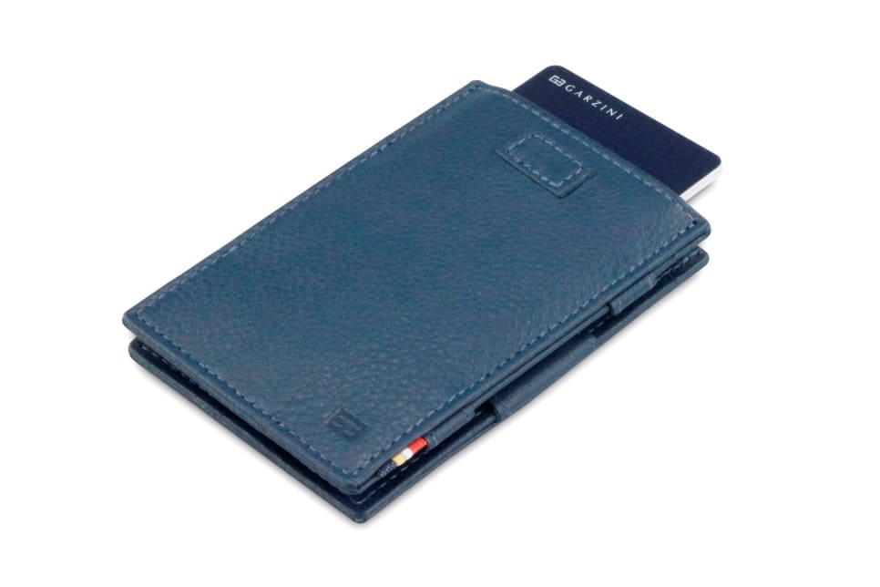 Front view of Cavare Magic Wallet Card Sleeve Nappa in Navy Blue with pull tab and card pulling out.