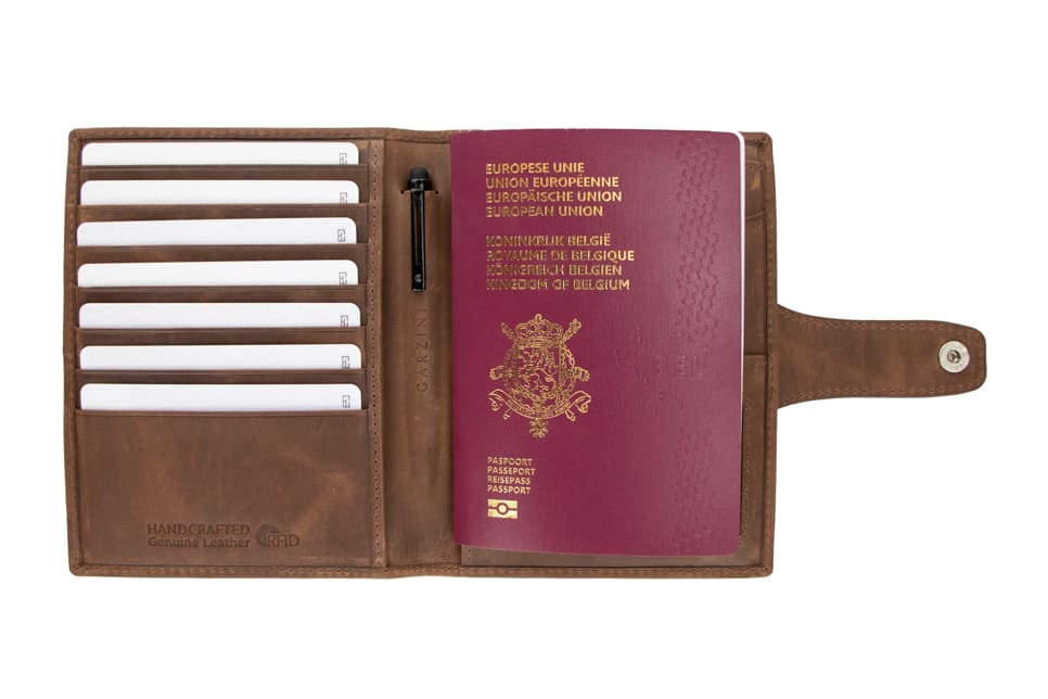 Open view of the AirTag Passport Holder in Brushed Brushed Brown with cards and passport inside. 