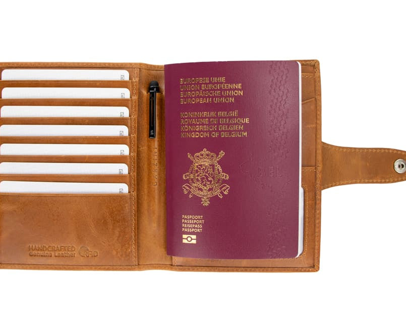 Open view of the AirTag Passport Holder in Brushed Brushed Cognac with cards and passport inside. 