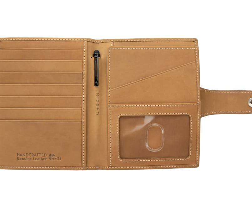 Open view of the AirTag Passport Holder in Vintage Camel Brown with no cards.
