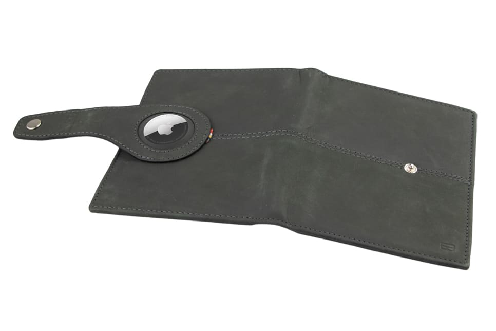 Open outside view with AirTag of the AirTag Passport Holder in Vintage Carbon Black.