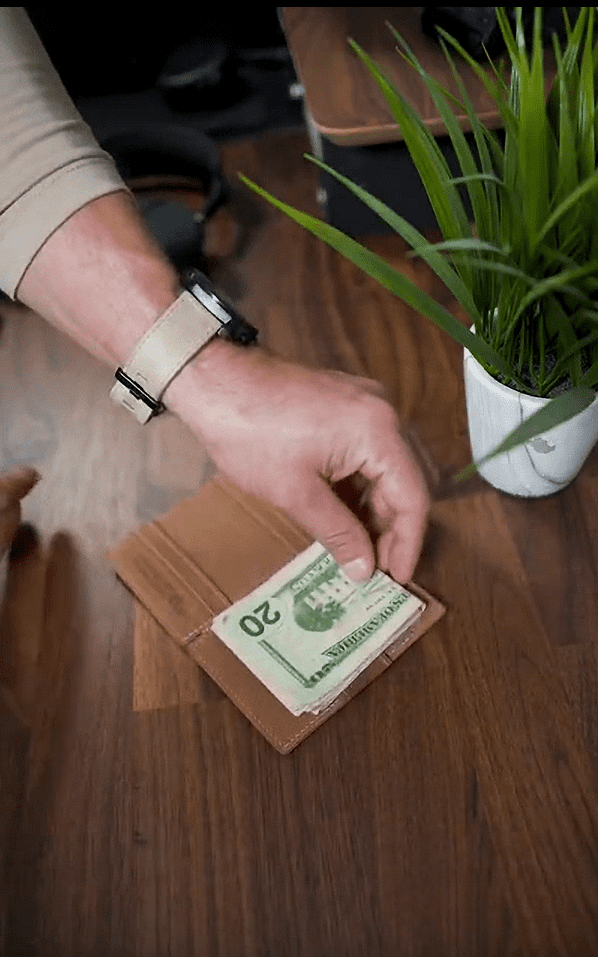 garzini wallet with a hand putting money in it